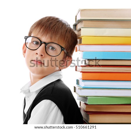 Cute schoolboy and heap of books on white background, closeup