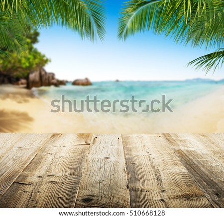 Empty wooden planks with tropical beach on background. Ideal for product placement