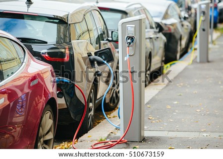 Charging modern electric cars (new energy vehicles, NEV) on the street station Royalty-Free Stock Photo #510673159