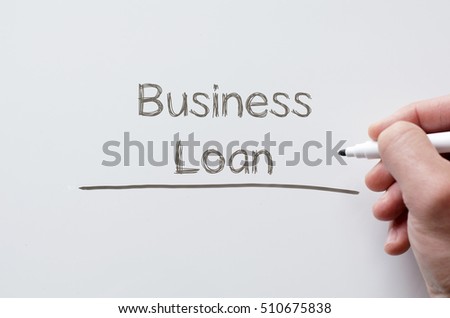 Human hand writing business loan on whiteboard