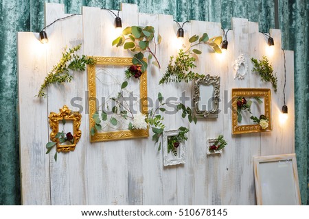 vintage frames and flowers hanging on the wall. festival decoration