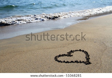 Heart sing on the beach with waves