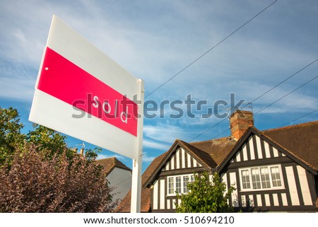Estate agency sold sign for a traditional English property. UK real estate market is a lucrative business. 
