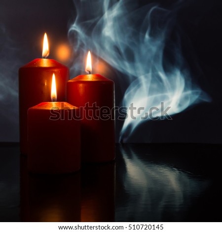 Burning candles with smoke and fume in the background