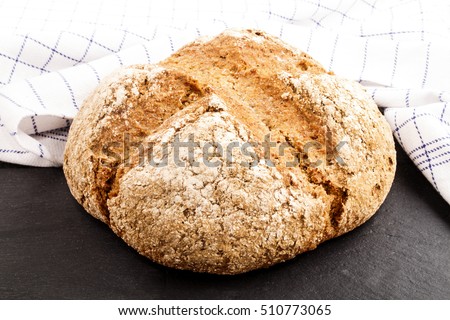 warm, freshly baked irish soda bread on slate Royalty-Free Stock Photo #510773065