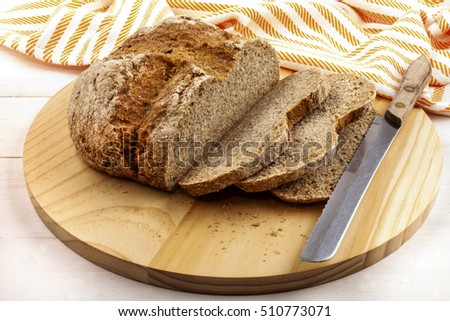 sliced irish soda bread on a wooden plate and bread knife Royalty-Free Stock Photo #510773071