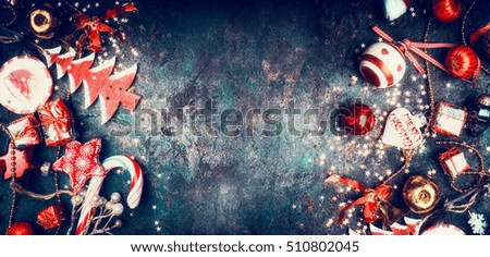 Christmas vintage background with sweets and red holiday decorations: Santa hat, tree, star,balls, top view, border