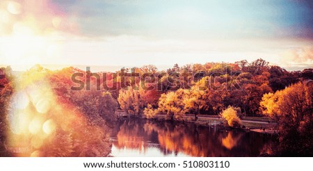 Autumn landscape of  City Park with colorful trees and lake at sunset light with bokeh, panoramic banner