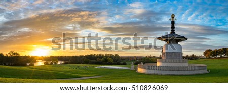 Panorama of Peace Pagoda temple at sunrise in Willen Park, Milton Keynes, UK Royalty-Free Stock Photo #510826069