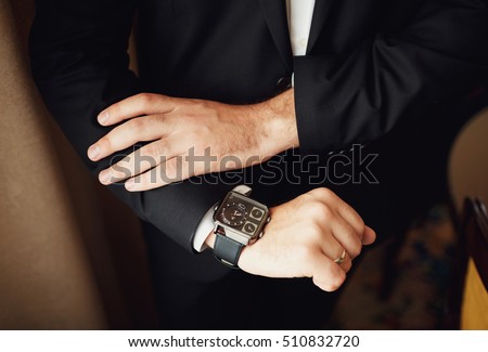 Expensive watch on the hand of a groom