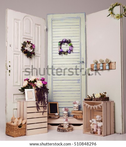 Interior decoration setup with flowers and picture frame.Pink doors,flowers,apple boxes.Great for wedding interior