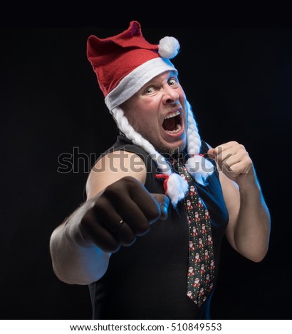 Emotional comic actor man in cap with braids gesticulates on a black background, in anticipation of Christmas and New Year