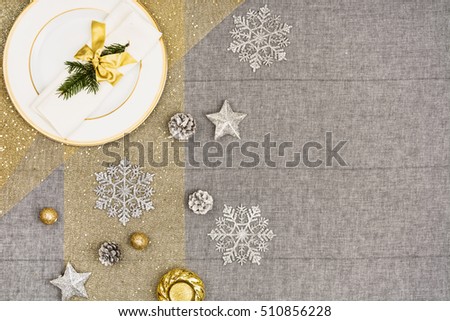 Christmas table seen from above, top view. Linen, vintage background with visible texture. Mock up with a lot of copy space for text or graphical elements.