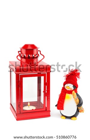 Red lantern with penguin figurine for christmas isolated on white background