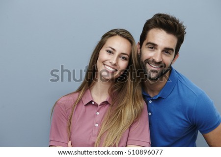 Happy couple smiling in polo shirts, portrait