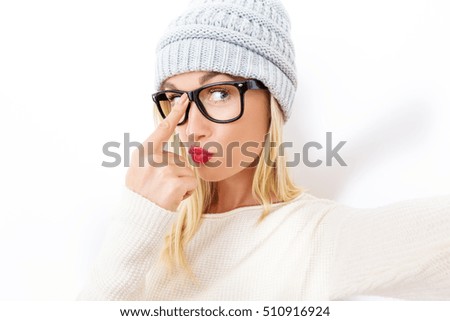 Young woman in winter clothes taking a selfie
