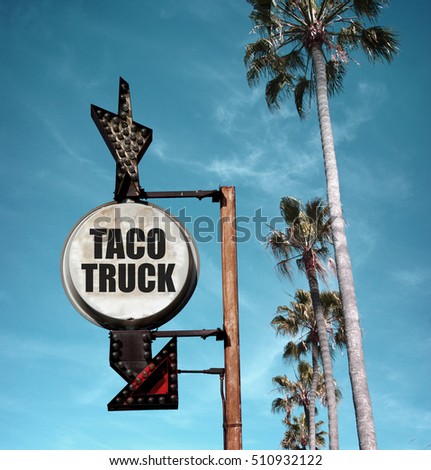 aged and worn vintage photo of taco truck sign with palm trees