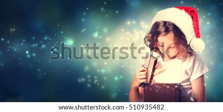 Girl with Santa Hat Opening a Gift Box