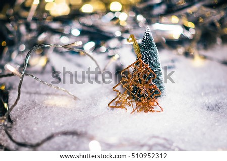 miniature Christmas tree in the snow and  decorations