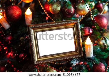 Empty blank photo frame in christmas decorated background with toys and candle lights
