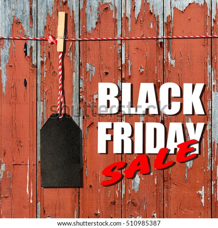 Black friday. Black sale tag on the wooden planks background