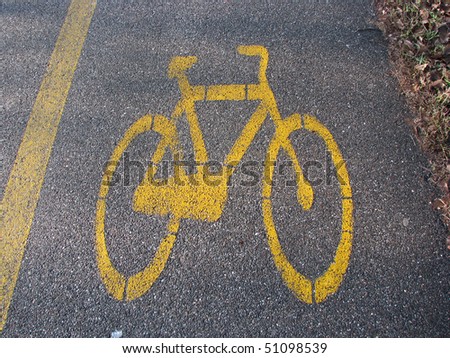 Yellow cycle signal on asphalted bicycle lane
