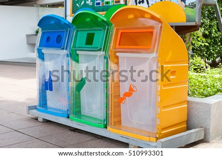 Three recycle containers for glass, plastic ,other 