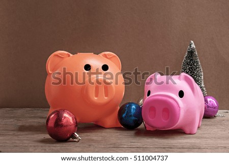 Christmas tree, piggy bank and Christmas balls on wooden background,image to Saving Money for Christmas Holiday decoration concept.