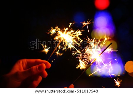 beautiful bright celebratory sparkler in woman hands