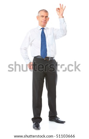 Happy mature businessman standing showing ok sign, meaning success in business. Full body image, isolated over white background.