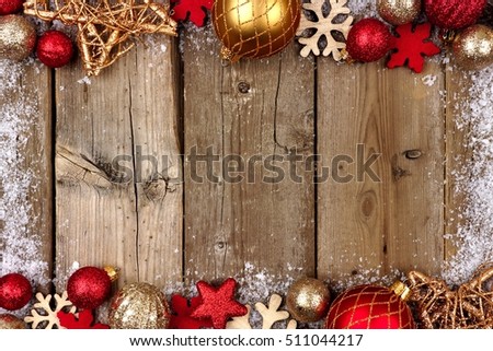 Red and gold Christmas ornament double border with snow frame on a rustic wood background