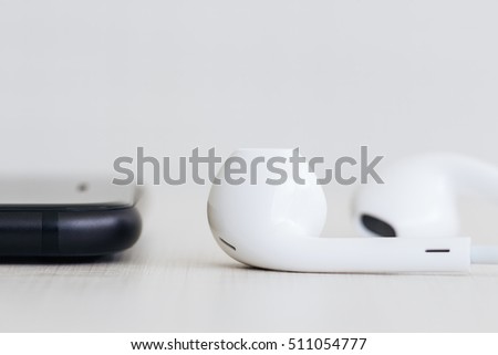 phone and headphones on wood side view