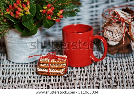 Christmas gingerbread cookies in stack. Holiday concept decorated with fir tree and cranberry . Selective focus.

