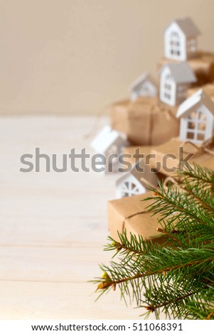 Christmas gifts with snowflakes. Small white houses. Walnuts.