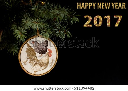Happy New Year 2017 on the Chinese calendar of rooster template card with hand made decoupage rooster and decorated text design polygonal font. Isolated on black background. Copyspace text and logo.