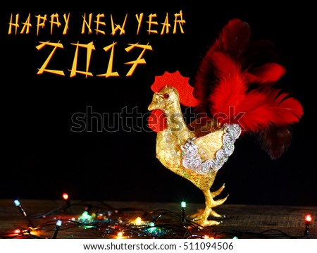  Happy New Year 2017 on the Chinese calendar of rooster template card with hand made craft gold rooster and decorated text design font. Isolated on black background. Copyspace text and logo.