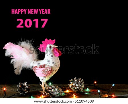 Happy New Year 2017 on the Chinese calendar of rooster template card with hand made craft pink rooster and decorated text design font. Isolated on black background. Copyspace text and logo.