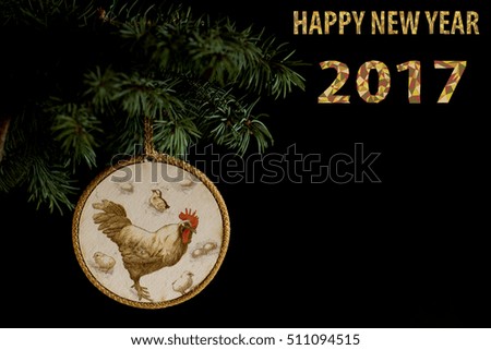 Happy New Year 2017 on the Chinese calendar of rooster template card with hand made decoupage rooster and decorated text design polygonal font. Isolated on black background. Copyspace text and logo.