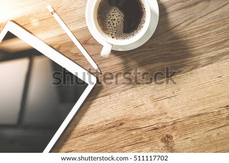 Coffee cup and Digital tablet dock smart keyboard,eyeglasses,stylus pen on wooden table,Social distancing and Working from home concept.
