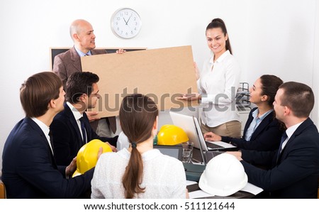 Adult businessman presents new development plan at poster in the office