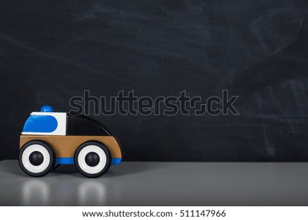 toy car in front of chalkboard