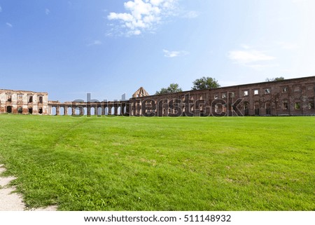  the ruins picture ancient fortress of the 16th century, situated in the village of Ruzhany Grodno region, Belarus, blue sky and green grass on the lawn