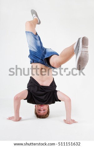 Young white b-boy dancing break dance.Little hip hop dancer guy isolated on white.Good looking teenager breaker posing in the studio on cut out white background.Cool teenage male model break dancing Royalty-Free Stock Photo #511151632