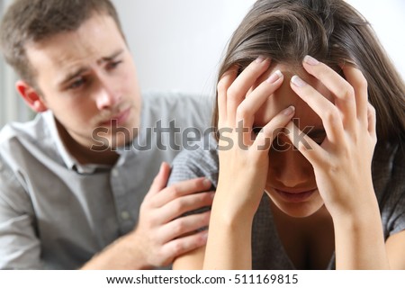 Meeting of a sad woman and a friend or boyfriend trying to comfort her at home Royalty-Free Stock Photo #511169815