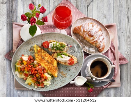 Light picture of traditional France breakfast on wooden table