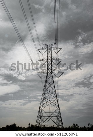 High voltage transmission towers with sky background. In black and white photo.