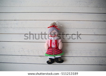 grandma's doll rests on a wooden background
