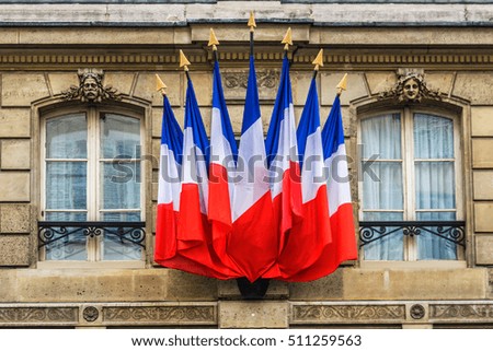The building is decorated with the flags of the French Republic. Paris, France.