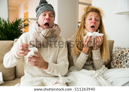 Sick couple catch cold. Man and woman sneezing, coughing. People got flu, having runny nose. Royalty-Free Stock Photo #511263940