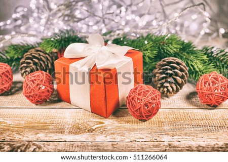 New Year's gifts. Christmas composition with branches of a fir-tree and cones on a wooden background. Selective focus. Vintage toning